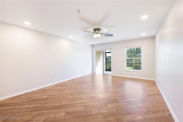 unfurnished room with ceiling fan and light hardwood / wood-style flooring