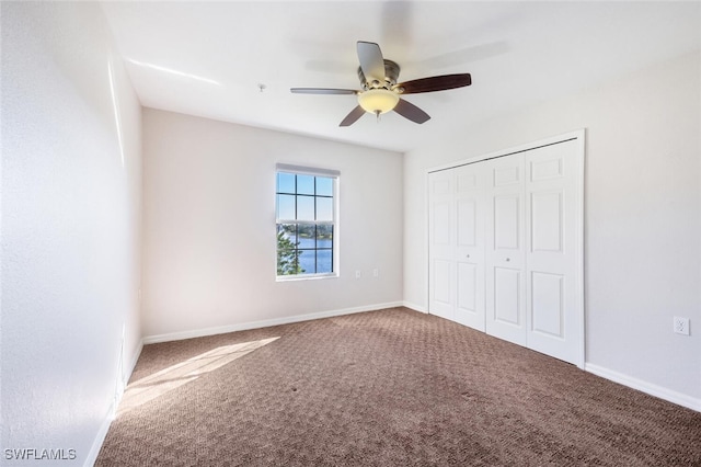 unfurnished bedroom with ceiling fan, a closet, and carpet floors