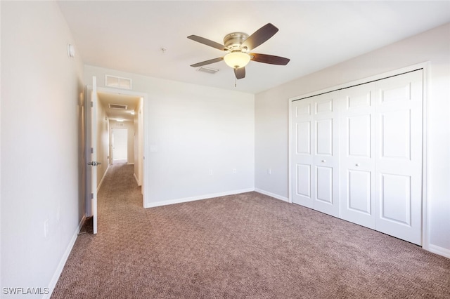 unfurnished bedroom with ceiling fan, a closet, and carpet