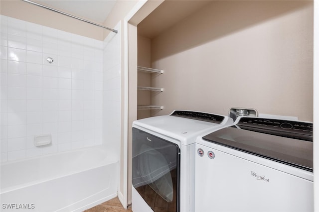 clothes washing area with separate washer and dryer