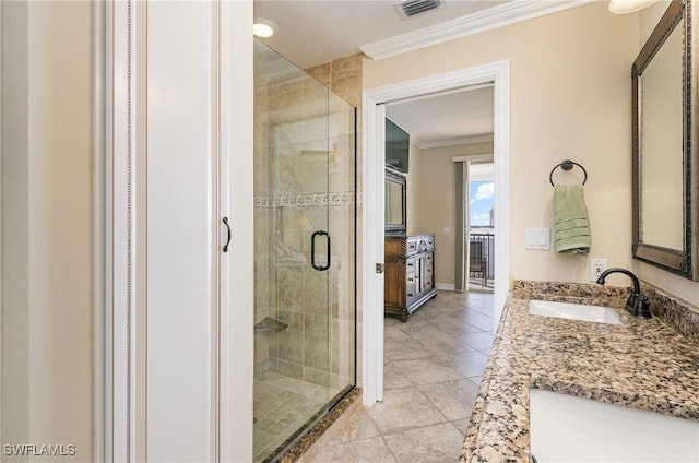 bathroom with tile patterned floors, crown molding, a shower with door, and vanity