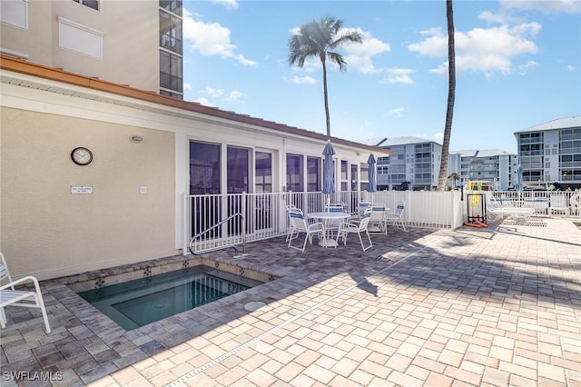 view of pool with a patio area and a community hot tub