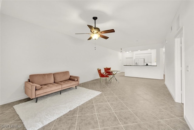 sitting room featuring ceiling fan and light tile patterned flooring