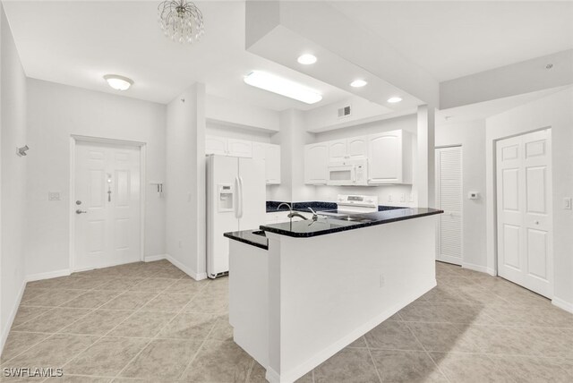 kitchen featuring white cabinets, white appliances, kitchen peninsula, and light tile patterned floors