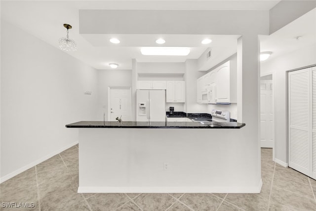 kitchen with white appliances, light tile patterned floors, decorative light fixtures, dark stone countertops, and white cabinetry