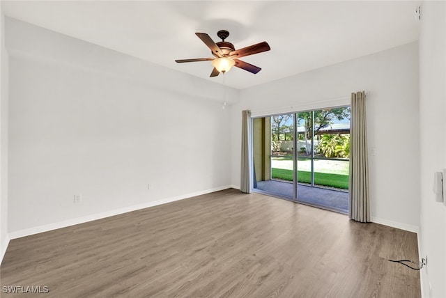 spare room with hardwood / wood-style flooring and ceiling fan