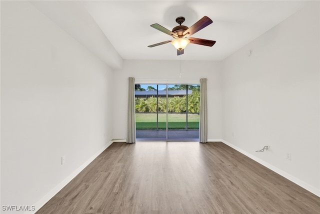 empty room with ceiling fan and hardwood / wood-style flooring