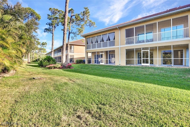 1101 Winding Pines Cir Unit 107, Cape Coral, FL 33909 - back of house featuring stucco siding and a lawn