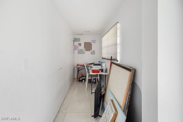 hall with light tile patterned floors