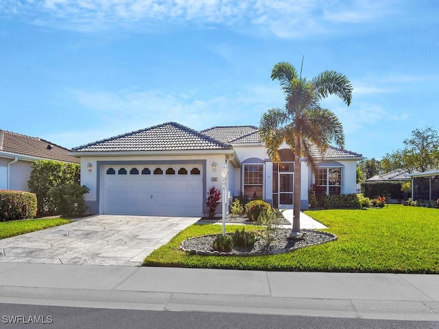 mediterranean / spanish-style house with a garage and a front lawn