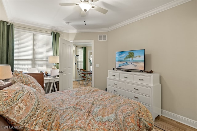 bedroom featuring ceiling fan, light hardwood / wood-style floors, and ornamental molding