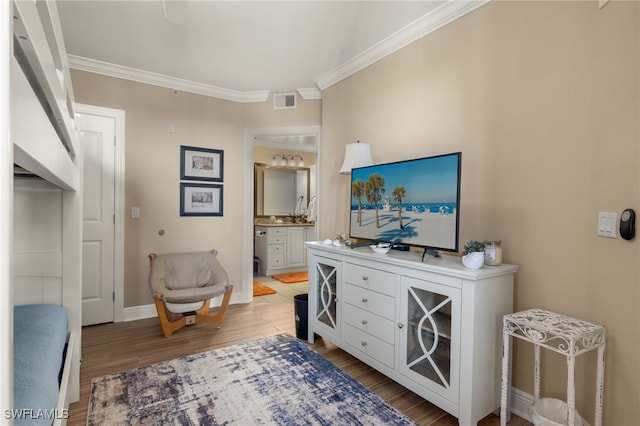 interior space featuring hardwood / wood-style floors and ornamental molding