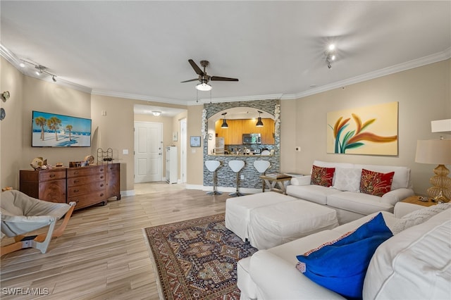 living room featuring ceiling fan, light hardwood / wood-style floors, and ornamental molding