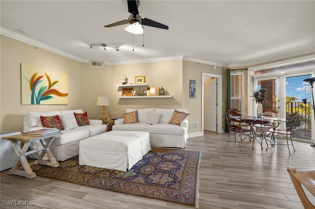 living room with crown molding, hardwood / wood-style floors, and ceiling fan