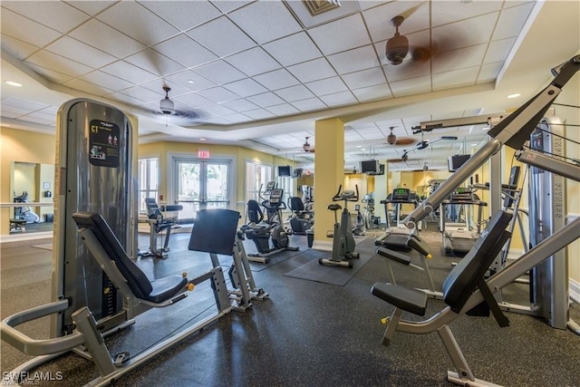 exercise room featuring a paneled ceiling, ceiling fan, and french doors