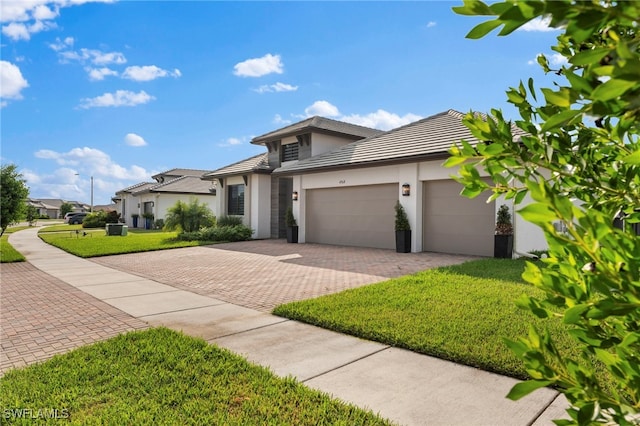 prairie-style home featuring a garage and a front yard