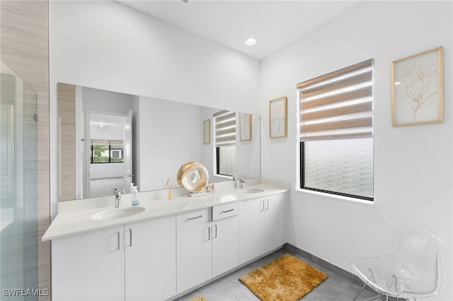 bathroom featuring tile patterned floors, vanity, and a shower with shower door