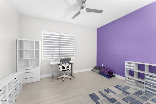 home office with ceiling fan and light hardwood / wood-style flooring