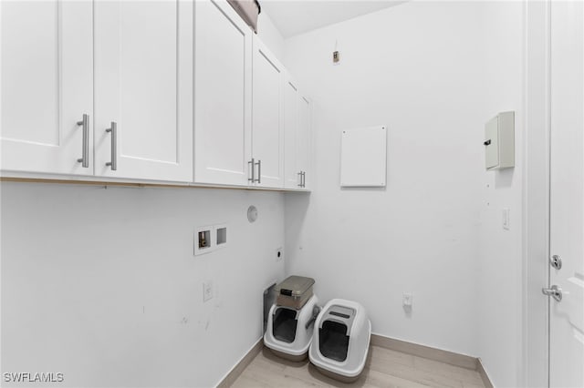 laundry room with cabinets, hookup for a washing machine, light hardwood / wood-style floors, and electric dryer hookup