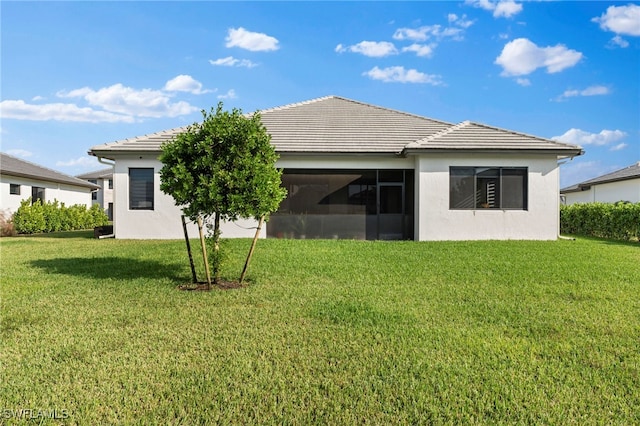 back of house with a lawn