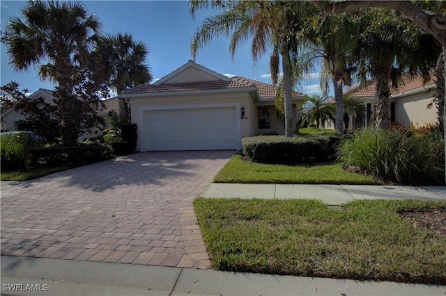 8748 Querce Ct S, Naples, FL 34114 - mediterranean / spanish home with stucco siding, decorative driveway, a garage, and a tiled roof