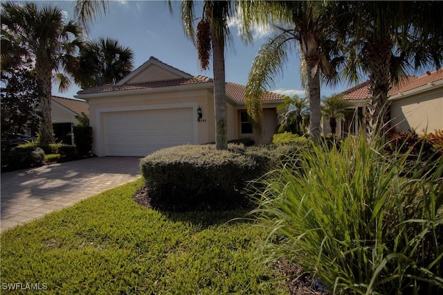 8748 Querce Ct S, Naples, FL 34114 - view of front of home featuring a garage, decorative driveway, a tiled roof, and stucco siding