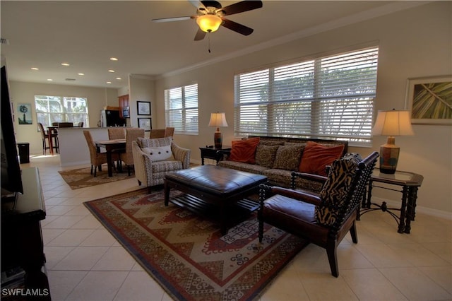 tiled living room featuring crown molding, ceiling fan, and a healthy amount of sunlight