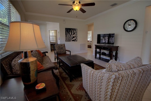 living room featuring tile patterned floors, plenty of natural light, crown molding, and ceiling fan