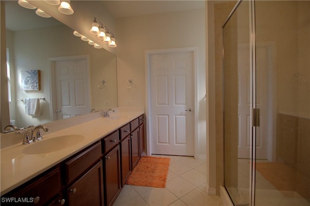 bathroom featuring tile patterned flooring, vanity, and a shower with door