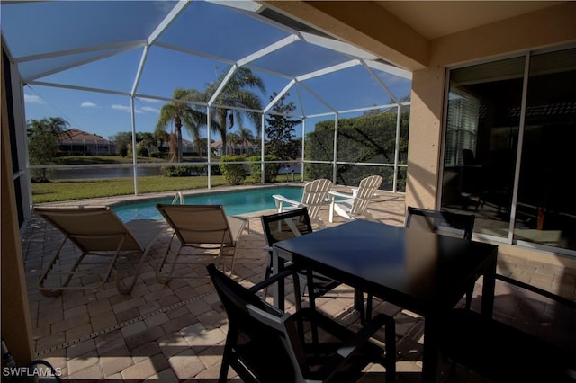 8748 Querce Ct S, Naples, FL 34114 - swimming pool with a patio area, a water view, outdoor dining area, and a lanai