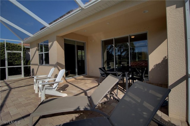 view of patio / terrace featuring glass enclosure