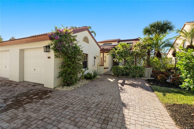 mediterranean / spanish-style house with a garage