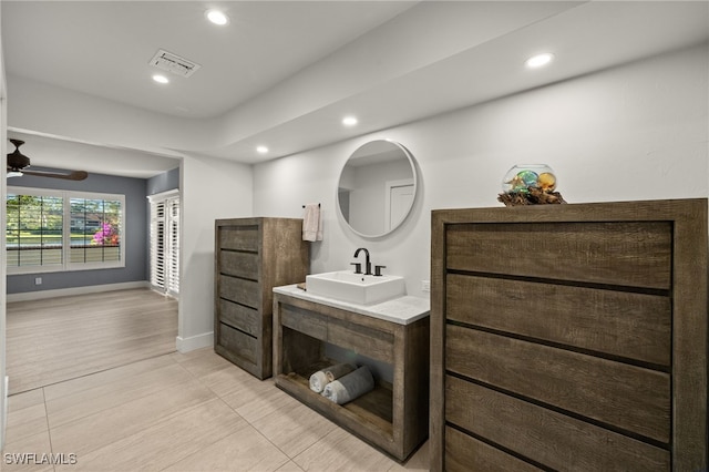 bathroom with hardwood / wood-style floors, ceiling fan, and vanity