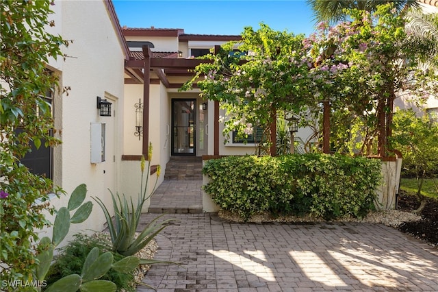 entrance to property with a pergola