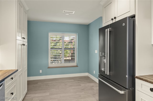 kitchen featuring white cabinetry, stainless steel appliances, and light wood-type flooring