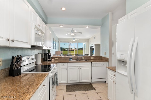 kitchen with white cabinetry, white appliances, sink, and light tile patterned floors