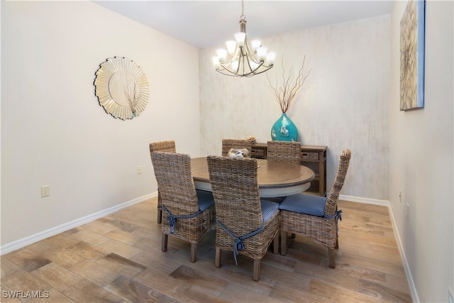 dining space with a notable chandelier and wood-type flooring