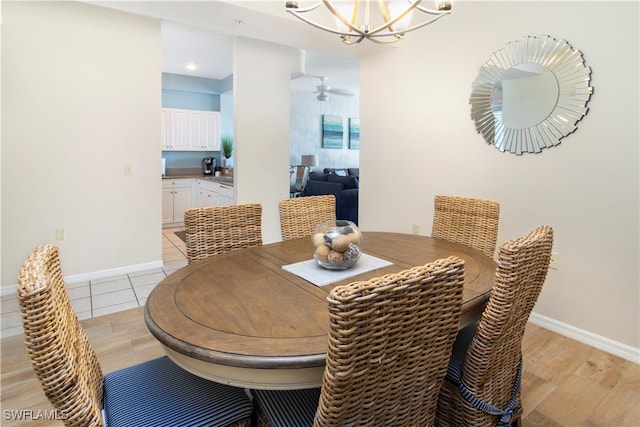 dining space with a chandelier and light wood-type flooring