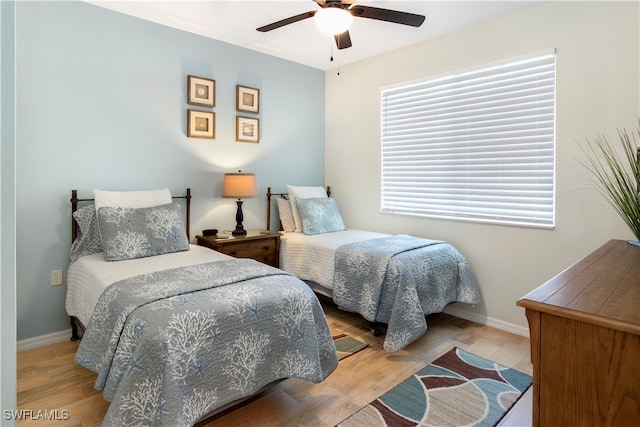 bedroom with ceiling fan and light hardwood / wood-style flooring