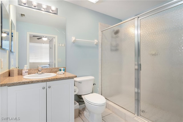 bathroom with toilet, tile patterned flooring, vanity, and walk in shower