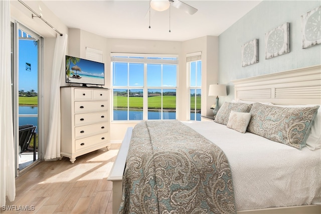 bedroom with access to outside, light hardwood / wood-style flooring, and ceiling fan