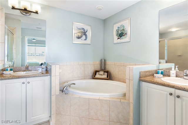 bathroom featuring vanity and independent shower and bath