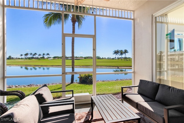 sunroom / solarium with a healthy amount of sunlight and a water view