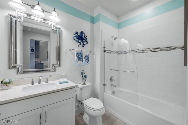 full bathroom with tiled shower / bath combo, toilet, wood-type flooring, and vanity