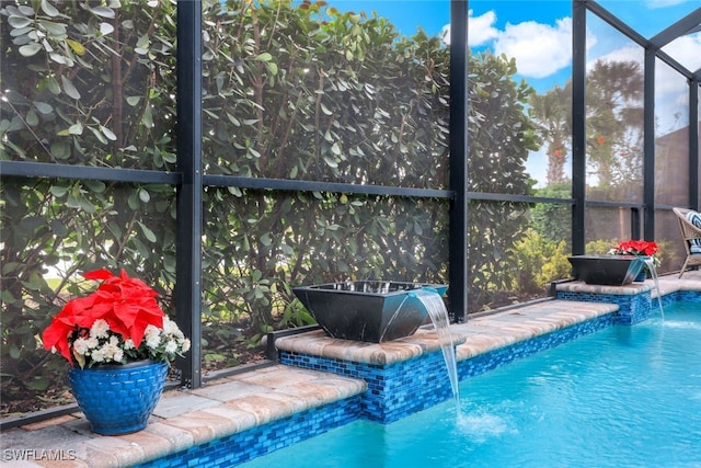 view of pool featuring pool water feature and a lanai