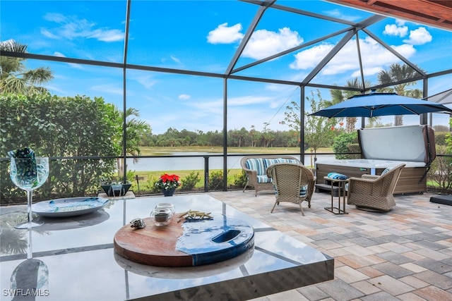 view of patio featuring a water view, glass enclosure, and an outdoor hangout area