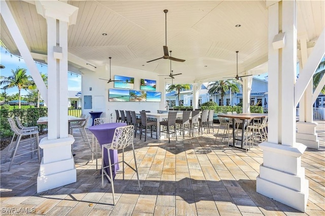 view of patio with ceiling fan and exterior bar