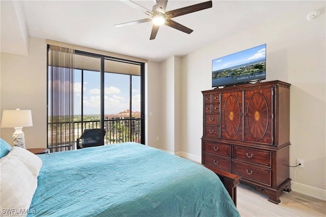 bedroom with ceiling fan, light hardwood / wood-style floors, access to exterior, and expansive windows