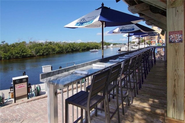 view of dock featuring a water view and exterior bar