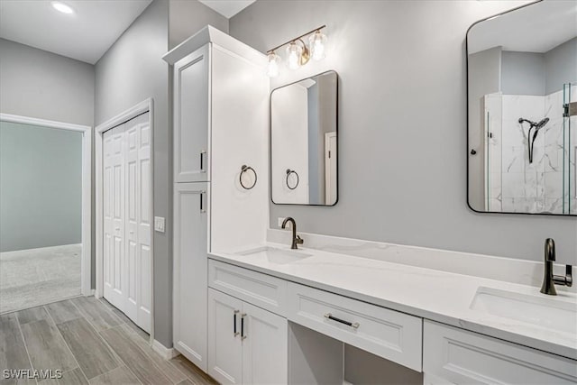 bathroom with vanity, wood-type flooring, and walk in shower